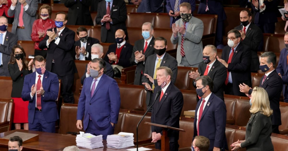 Rep. Paul Gosar of Arizona and Sen. Ted Cruz of Texas are applauded by Republican members of Congress after objecting to the certification of the Electoral College results during a joint session of Congress on Jan. 6, 2021, in Washington, D.C.