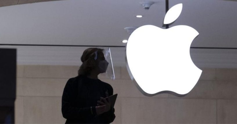 An Apple store employee is seen in New York on Feb. 5, 2021.