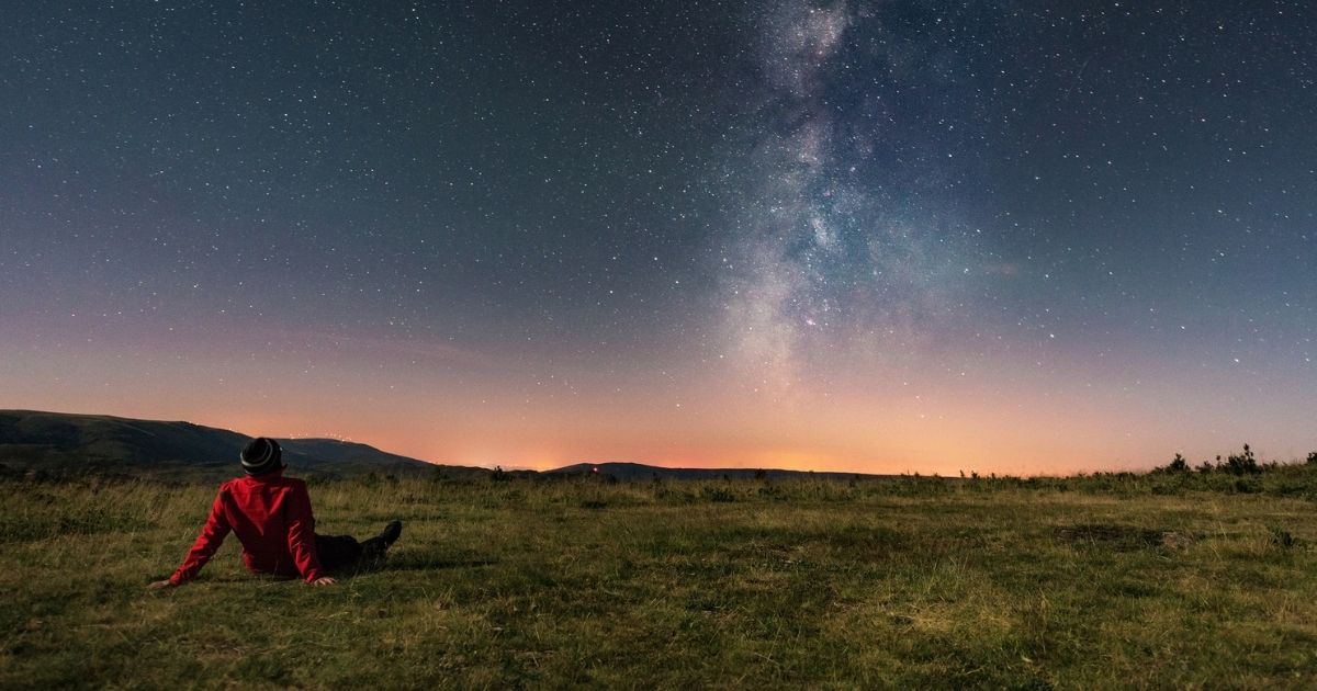 This stock photo portrays a man looking up at the sky. Scientists have released approximate times when the "Ring of Fire" phenomenon will be visible to sky-watchers.
