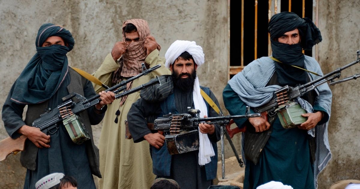 Afghan Taliban fighters listen to Mullah Mohammed Rasool in the Farah province of Afghanistan on Nov. 3, 2015.