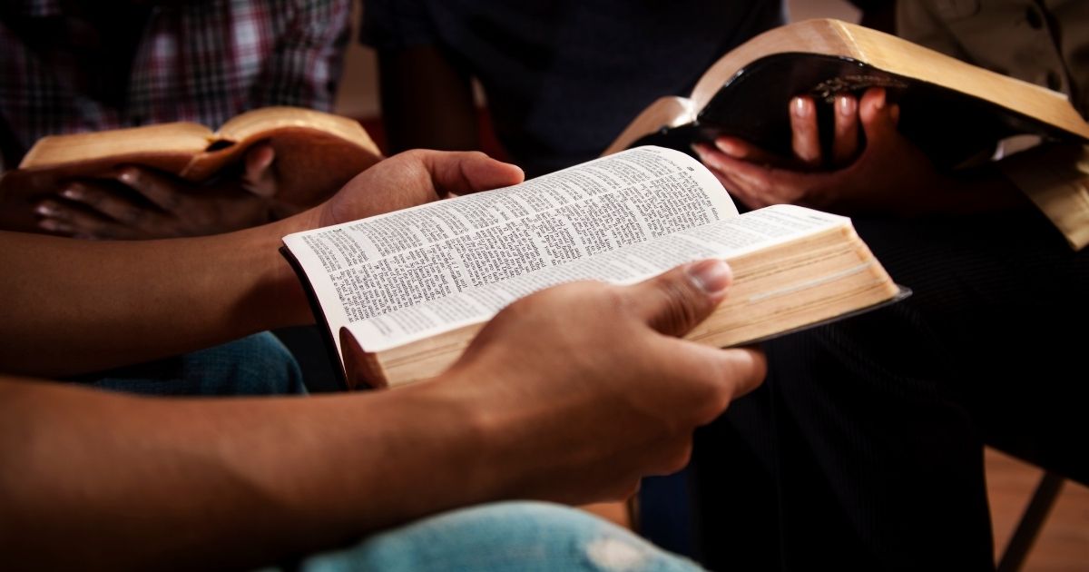 This stock photo portrays a group of young adults reading their Bibles together. Black theologian Voddie T. Baucham, an American-born pastor who now lives in Zambia, discusses what the Bible has to say about racism.