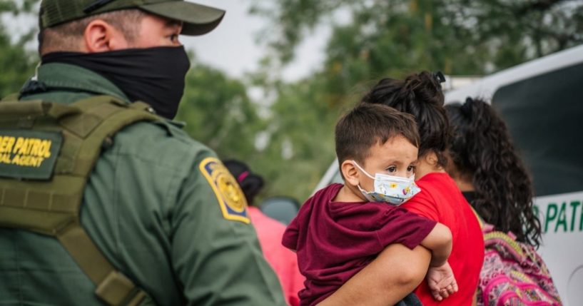 Immigrants seeking asylum wait to be processed by border patrol after crossing into the U.S. on June 16 in La Joya, Texas.
