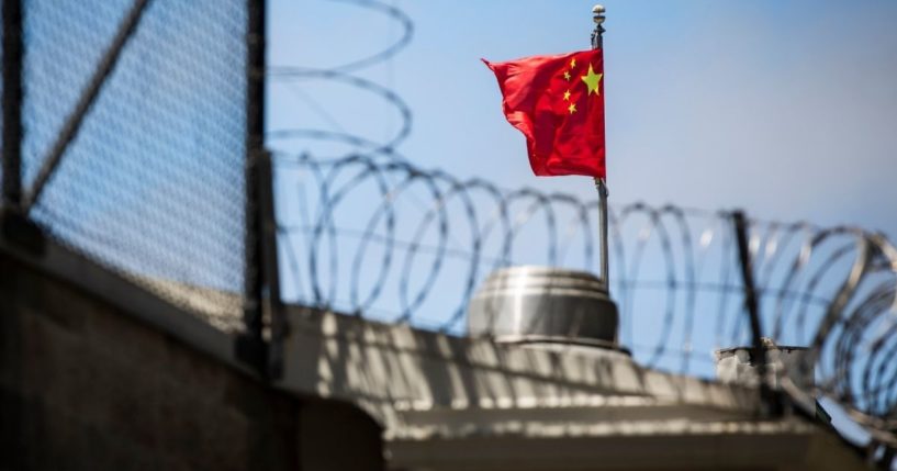 The flag of the People's Republic of China flies behind barbed wire at the Consulate General of the People's Republic of China in San Francisco on July 23, 2020.
