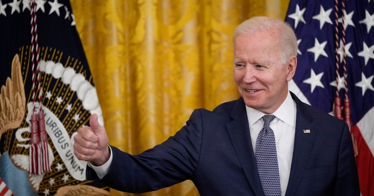 President Joe Biden gives the thumbs up to the audience in the East Room of the White House on Thursday in Washington, D.C.