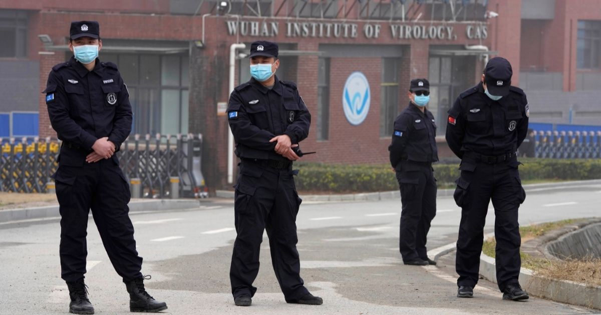 Security personnel stand guard near the entrance of the Wuhan Institute of Virology during a visit by World Health Organization inspectors in China's Hubei province on Feb. 3