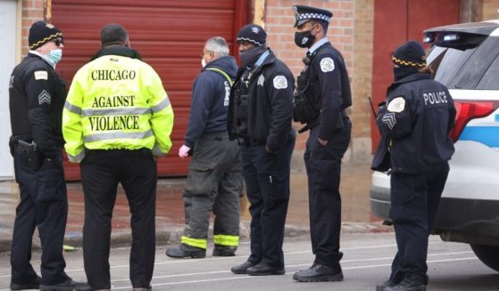 Chicago police secure the scene of a shooting that left at least two dead and 13 wounded in March.