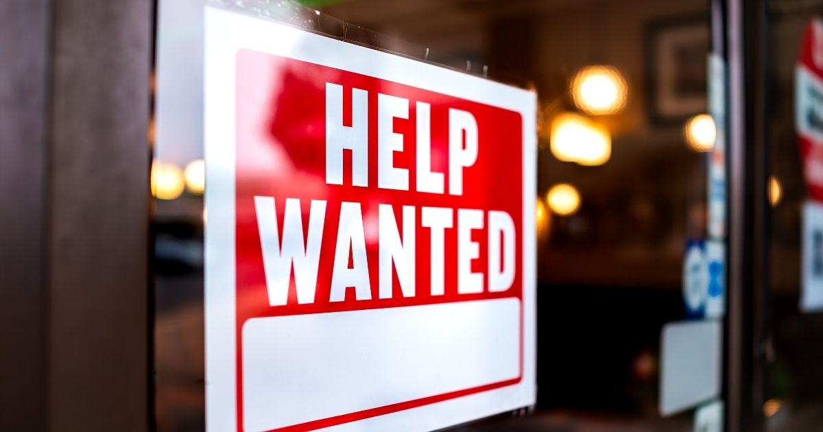 A "help wanted" sign on a door.