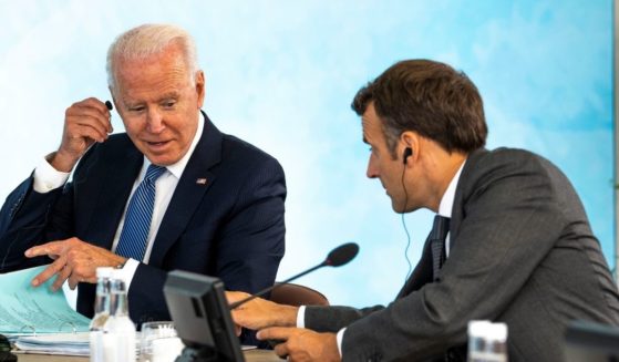 President Joe Biden talks with French President Emmanuel Macron during the final session of the G-7 summit in Cornwall, England, on Sunday.