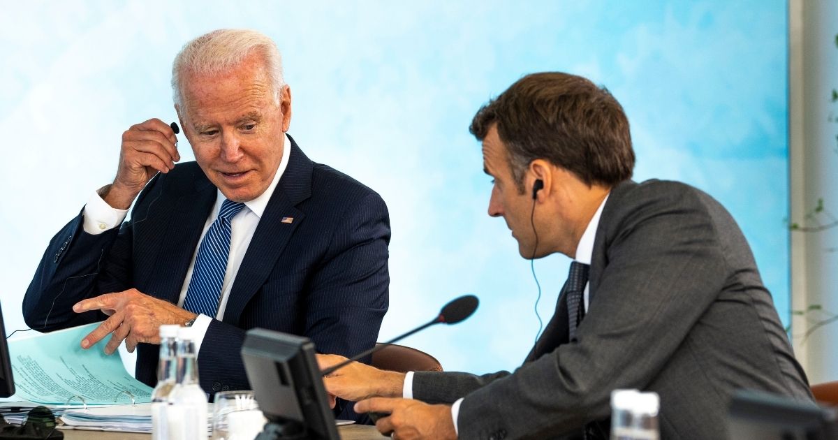 President Joe Biden talks with French President Emmanuel Macron during the final session of the G-7 summit in Cornwall, England, on Sunday.