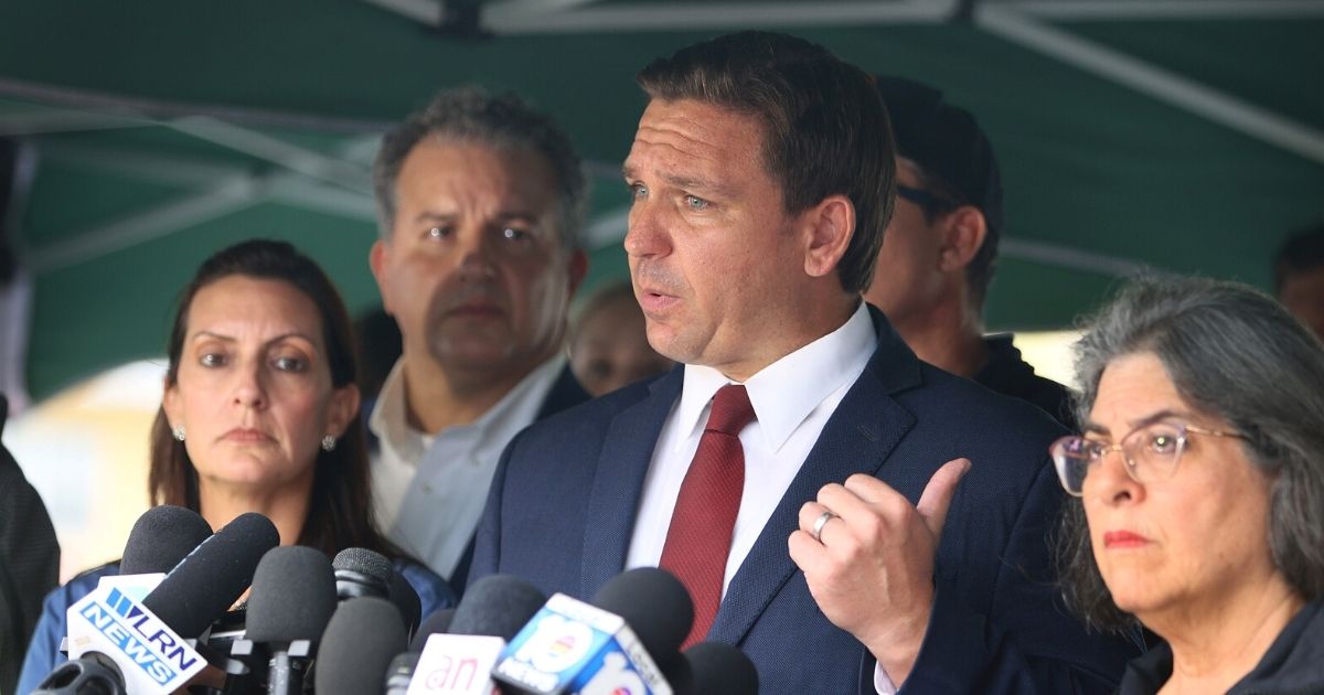 Florida Gov. Ron DeSantis fields questions at a news conference Thursday at the scene of the condominium collapse in Surfside, Florida.