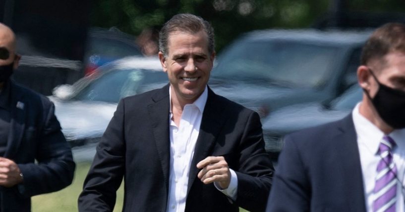 Hunter Biden grins for the cameras while walking to Marine One on the Ellipse outside the White House in a May 22 file photo.