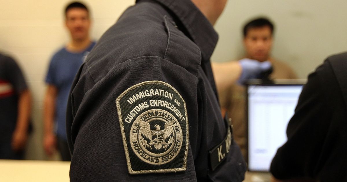 Illegal immigrants are photographed while being in-processed at an Immigration and Customs Enforcement center on April 28, 2010, in Phoenix.