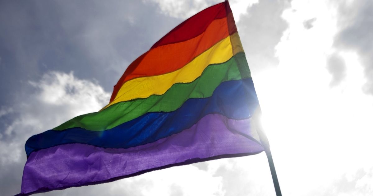 A reveller waves a rainbow flag during the Gay Pride Parade in Colombia on June 30, 2013.