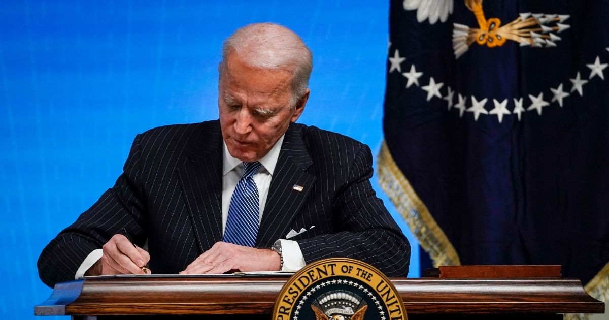 President Joe Biden signs an executive order related to American manufacturing in the South Court Auditorium of the White House complex on Jan. 25, in Washington, D.C.