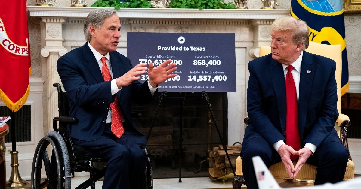 Then-President Donald Trump, right, speaks to reporters while hosting Texas Gov. Greg Abbott in the Oval Office at the White House on May 7, 2020, in Washington, D.C.