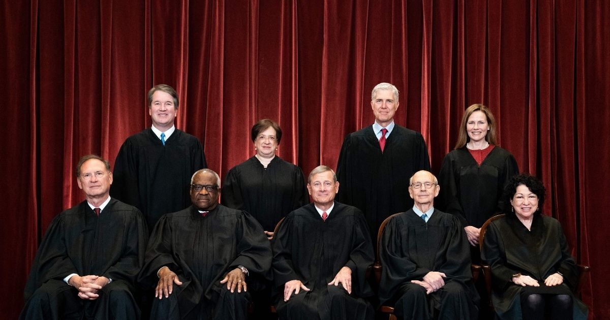 The Supreme Court justices pose during a group photo at the Supreme Court in Washington, D.C., on April 23.