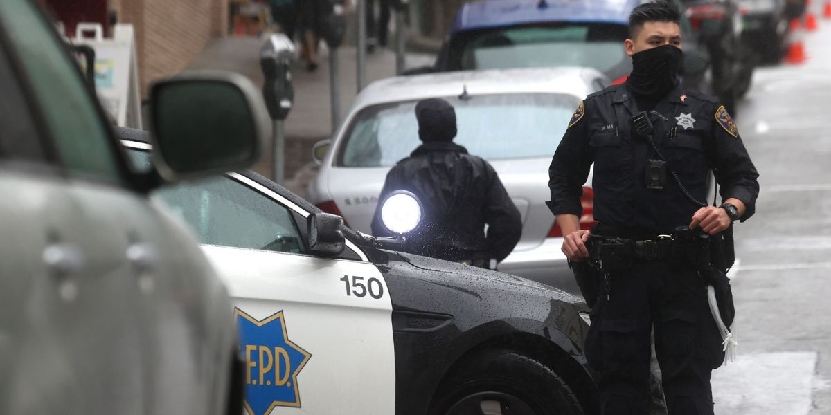 San Francisco police officer William Ma stands guard on a street corner in Chinatown on March 18, 2021, in San Francisco.