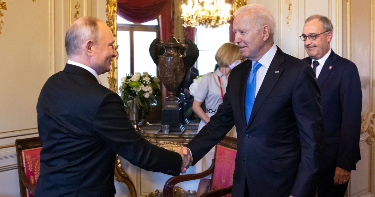 US President Joe Biden, right, shakes hands with Russian President Vladimir Putin prior to a meeting in Geneva on Wednesday.