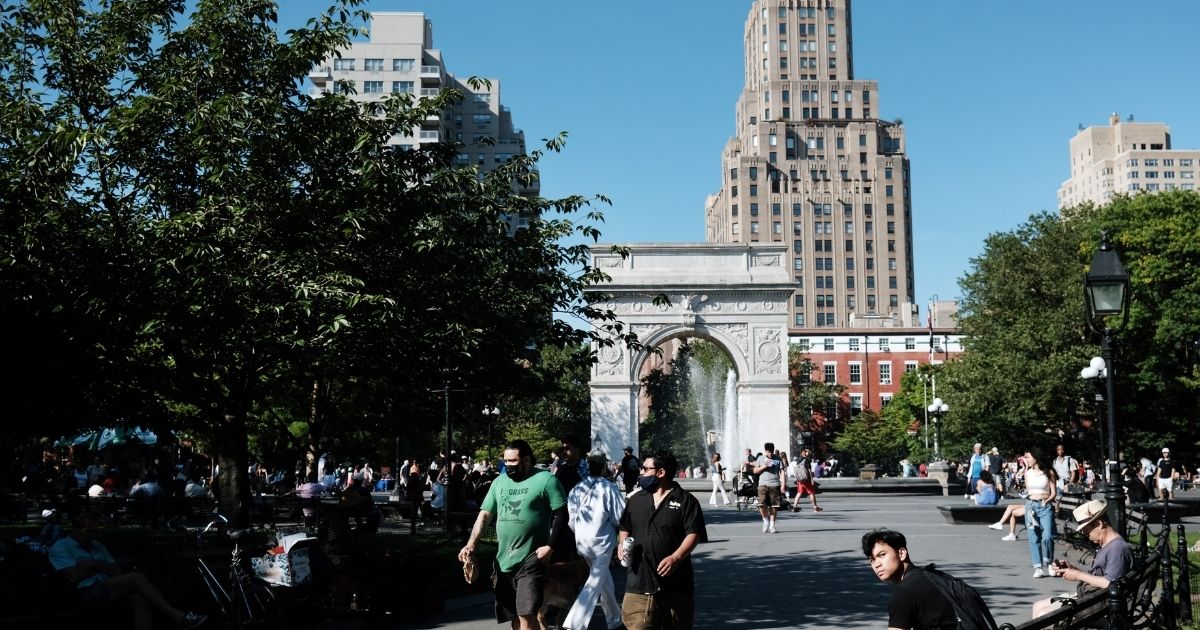 People enjoy a warm afternoon in Manhattan's Washington Square Park on June 10 in New York City.