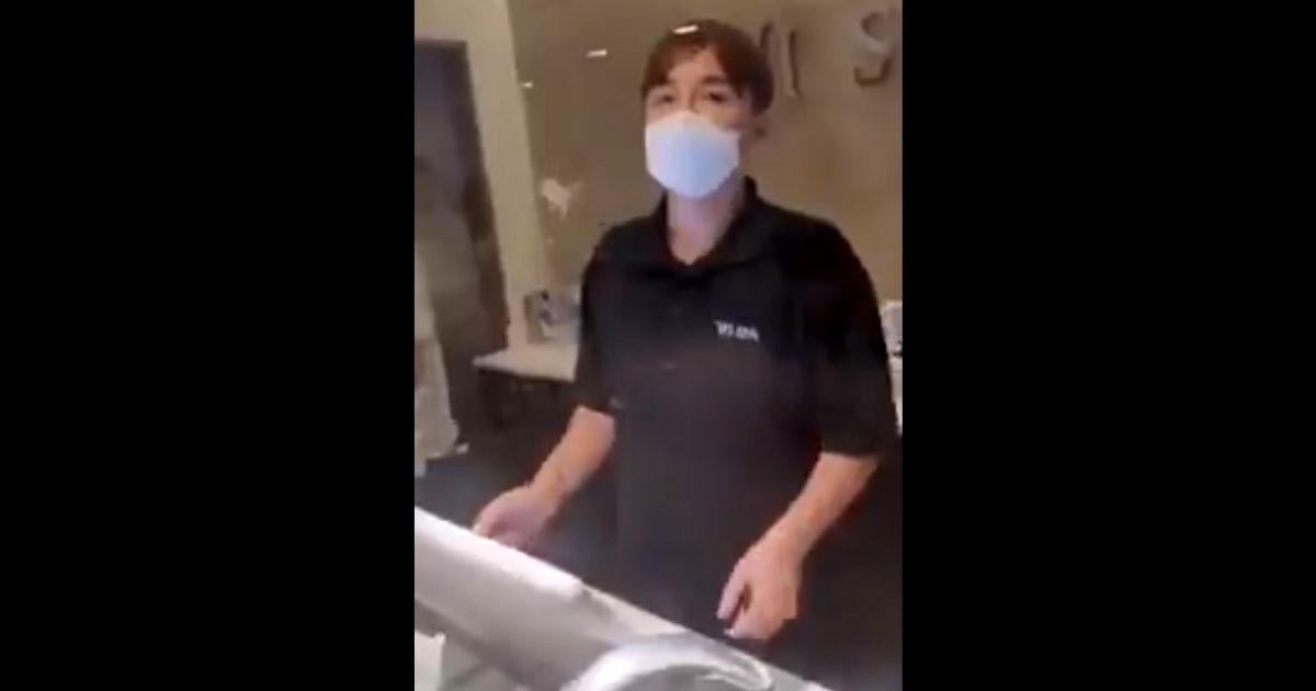 A worker at the Wi Spa in Los Angeles listens to an irate customer.