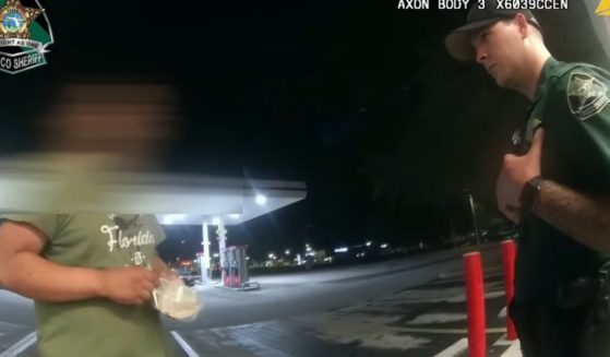 A Pasco County, Florida, deputy speaks to a man who was loitering near a gas station after he and another deputy bought the man shoes and some food.