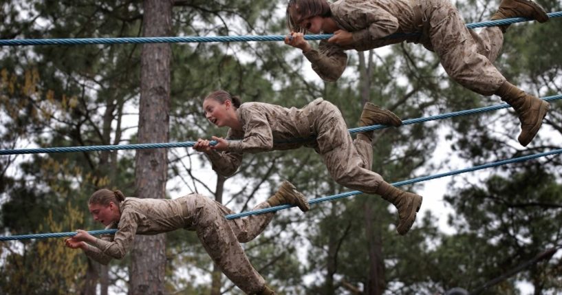 Female Marine recruits navigate an obstacle course during boot camp on Feb. 27, 2013, in Parris Island, South Carolina.
