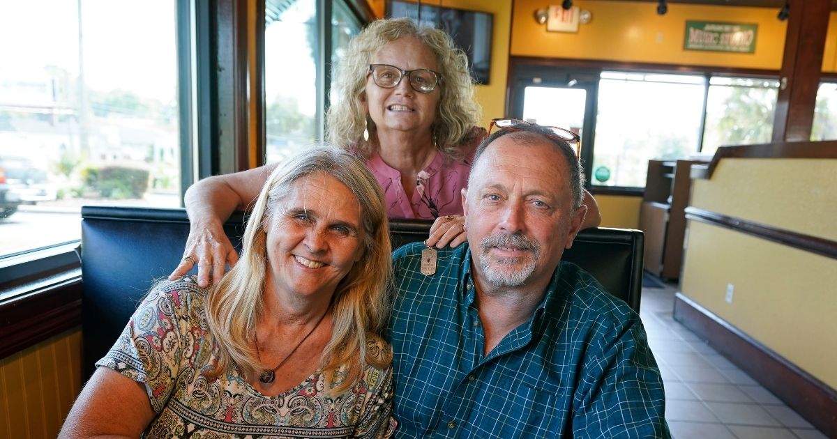 Two days after Debby-Neal Strickland, front left, and Jim Merthe, front right, were married in November, Debby donated a kidney to James' ex-wife Mylaen Merthe, center back. The three got together on May 25, 2021, at a restaurant in Ocala, Florida.