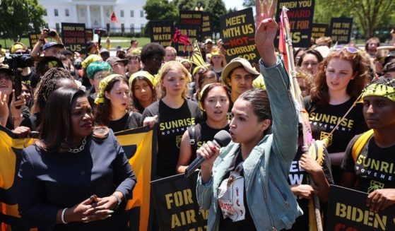 Democratic Reps. Cori Bush of Missouri, left, and Alexandria Ocasio-Cortez of New York rally with climate change activists in Lafayette Square on the north side of the White House on June 28, 2021, in Washington, D.C.