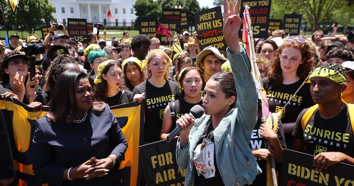 Democratic Reps. Cori Bush of Missouri, left, and Alexandria Ocasio-Cortez of New York rally with climate change activists in Lafayette Square on the north side of the White House on June 28, 2021, in Washington, D.C.