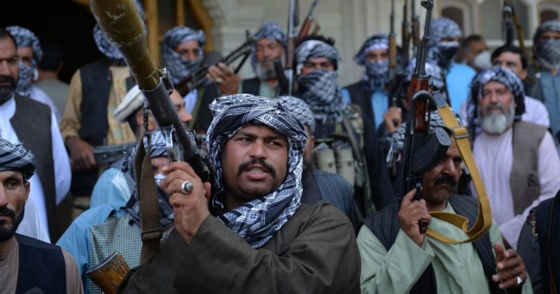 Afghan militia gather with their weapons to support Afghanistan security forces against the Taliban in Afghan warlord and former Mujahideen leader Ismail Khan's house in Herat on Friday.