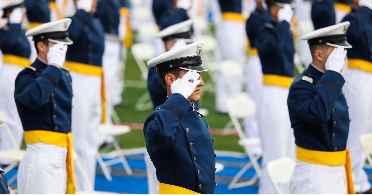 Members of the United States Air Force Academy class of 2021 salute during their graduation ceremony at Falcon Stadium on May 26, 2021, in Colorado Springs, Colorado.