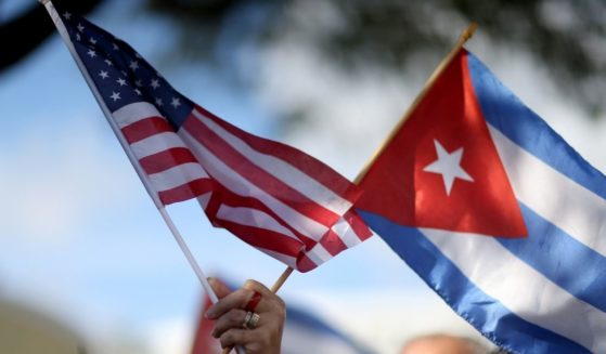A woman holds an American flag and a Cuban one at a protest on Dec. 20, 2014, in Miami.