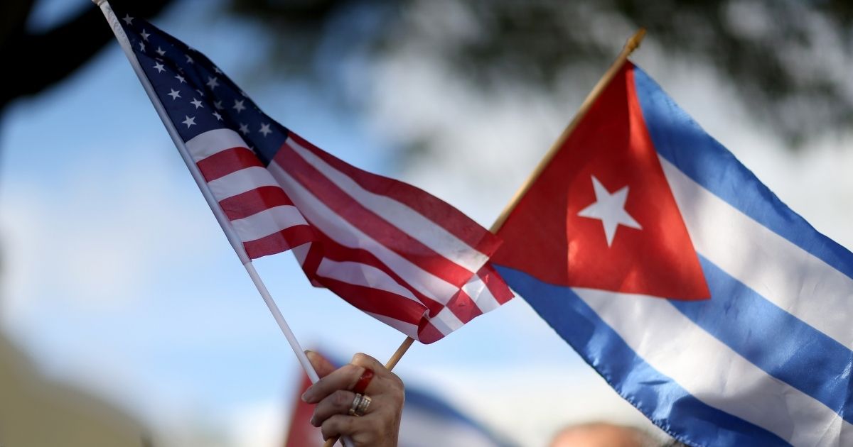 A woman holds an American flag and a Cuban one at a protest on Dec. 20, 2014, in Miami.