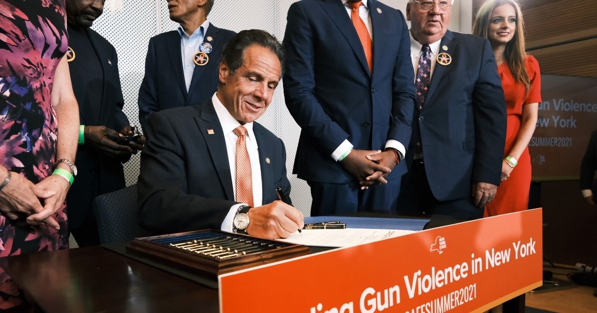 New York Gov. Andrew Cuomo signs a bill and declares a state of emergency due to gun violence on Tuesday in New York City.