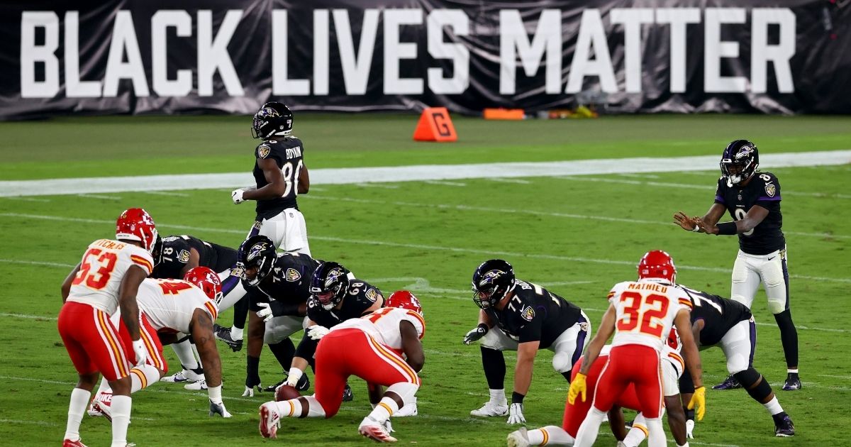 Baltimore Ravens quarterback Lamar Jackson waits for the snap in front a large "Black Lives Matter" banner during a game against the Kansas City Chiefs at M&T Bank Stadium in Baltimore on Sept. 28, 2020.