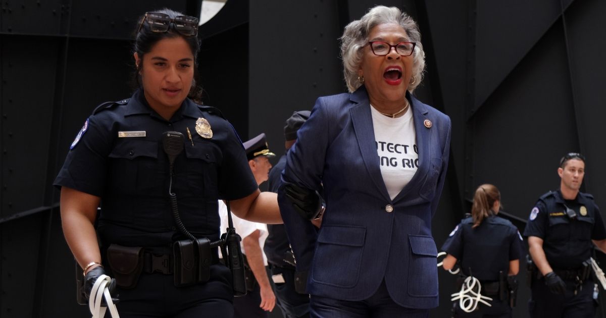 Democratic Rep. Joyce Beatty of Ohio is led away by a U.S. Capitol Police officer during a demonstration at the Hart Senate Office Building on Capitol Hill in Washington on Thursday.