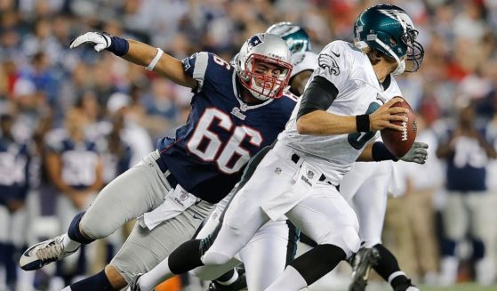 Jake Bequette of the New England Patriots chases Nick Foles of the Philadelphia Eagles during an NFL preseason game at Gillette Stadium in Foxboro, Massachusetts, on Aug. 20, 2012.