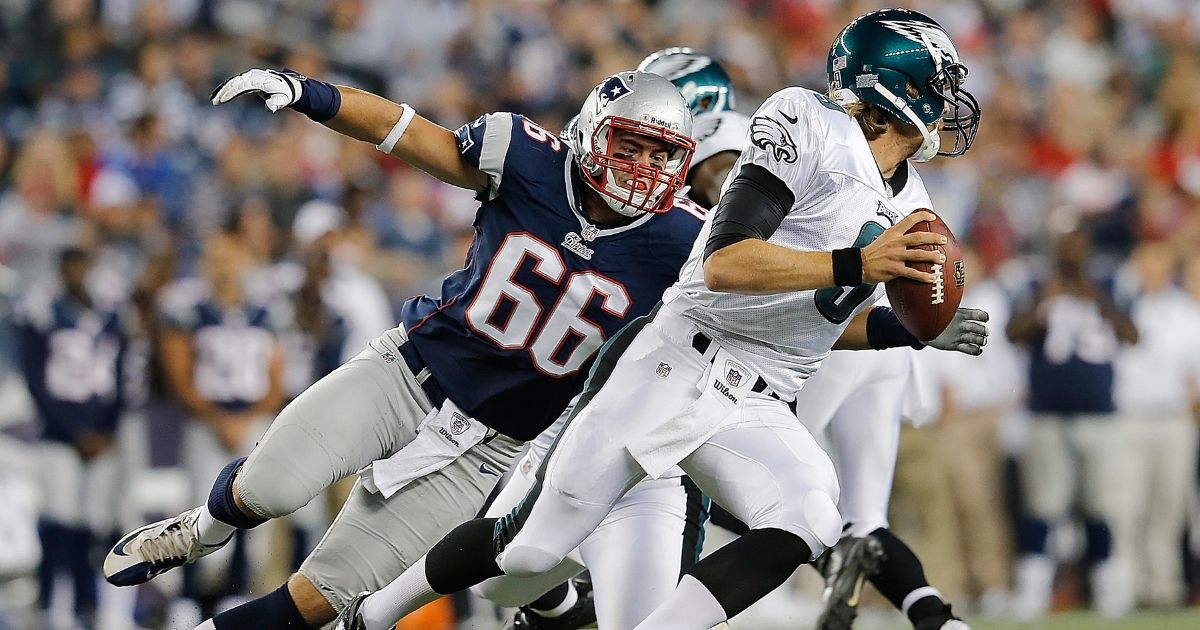Jake Bequette of the New England Patriots chases Nick Foles of the Philadelphia Eagles during an NFL preseason game at Gillette Stadium in Foxboro, Massachusetts, on Aug. 20, 2012.