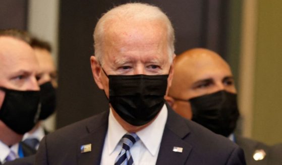 President Joe Biden and others wear masks as they arrive in Brussels for the NATO summit on June 14.
