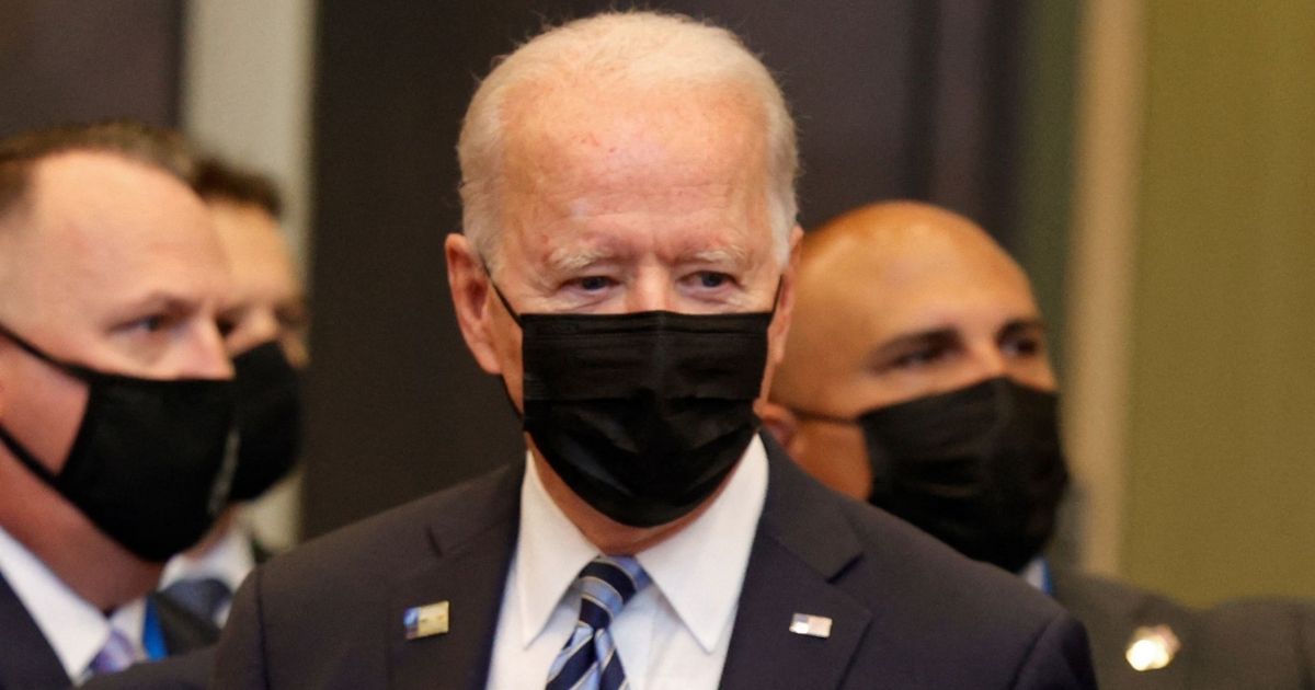 President Joe Biden and others wear masks as they arrive in Brussels for the NATO summit on June 14.