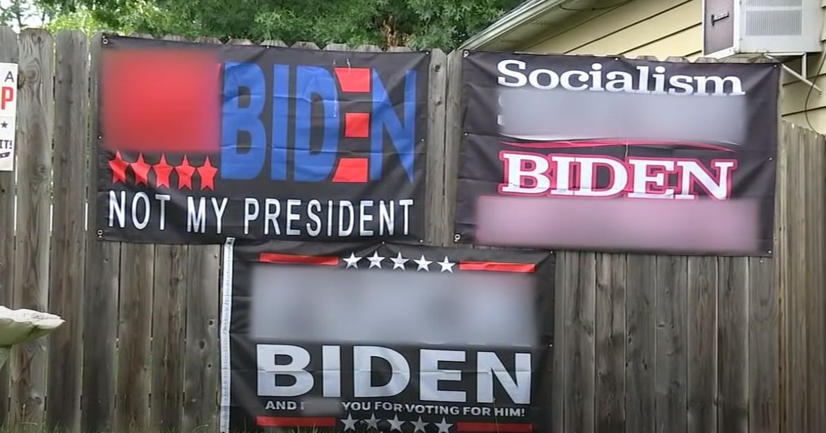 Signs decrying President Joe Biden with vulgar language are displayed at a home in Roselle Park, New Jersey.