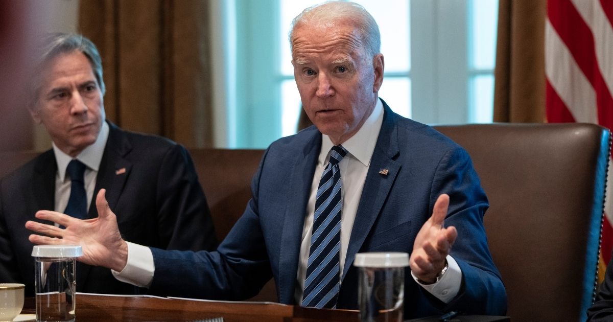 President Joe Biden speaks while Secretary of State Antony Blinken looks on at the start of a Cabinet meeting in the Cabinet Room of the White House in Washington on Tuesday.