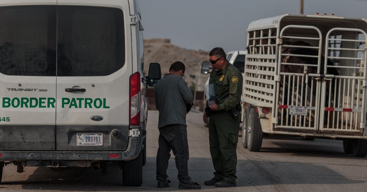 A man from El Salvador is processed by a U.S. Border Patrol agent in Sunland Park, New Mexico on Thursday.