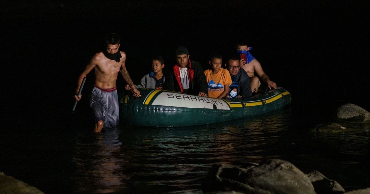 Migrants arrive on the banks of the Rio Grande after crossing the U.S.-Mexico border on a raft into the United States in Roma, Texas, on July 9, 2021.