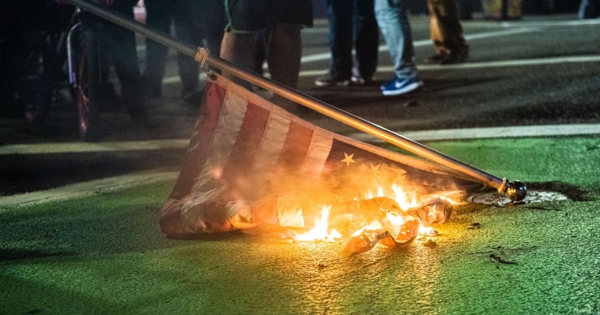 Protesters burn an American flag during a Black Lives Matter demonstration in Portland, Oregon, on Nov. 4.