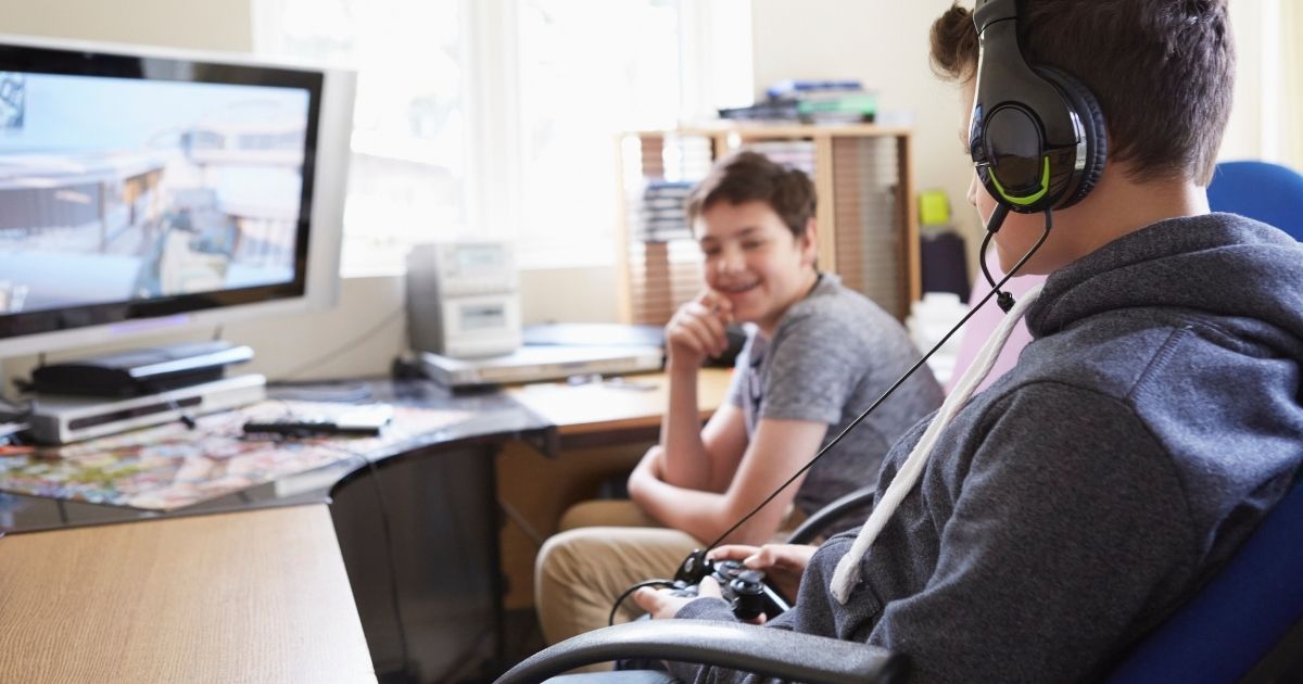This stock image portrays two boys playing video games on a PC computer. Computer company Dell will not be shipping some of its more energy-consuming gaming PCs to California and five other states because they utilize more energy than what standards now allow.