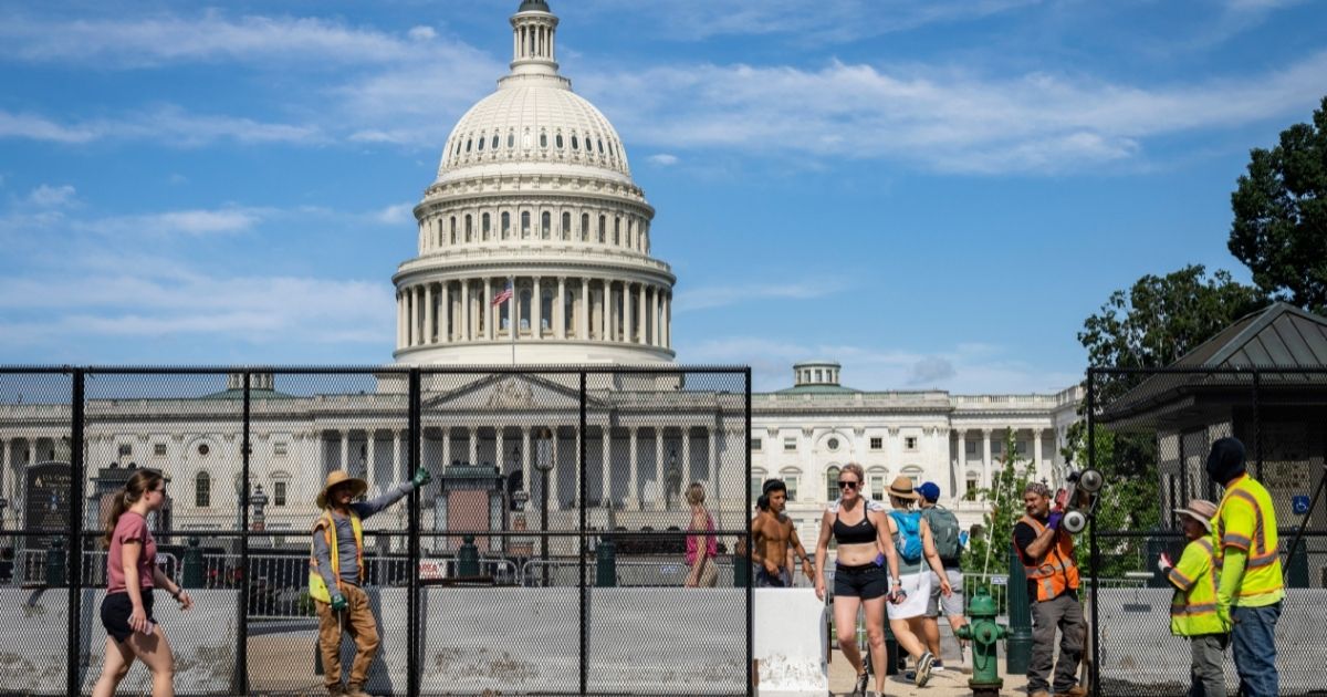 Members of the public exit and enter the Capitol plaza as workers remove security fencing surrounding the U.S. Capitol on July Sunday Washington, D.C.