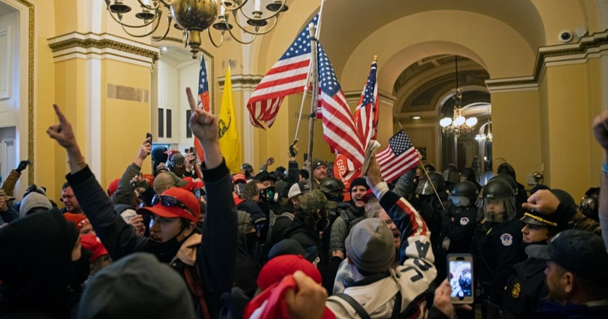 Demonstrators wave American flags during the incursion of the Capitol in Washington on Jan. 6.