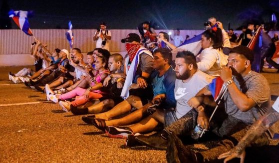 People block Palmetto Expressway during a protest showing support for Cubans demonstrating against their government, in Miami, on Tuesday.
