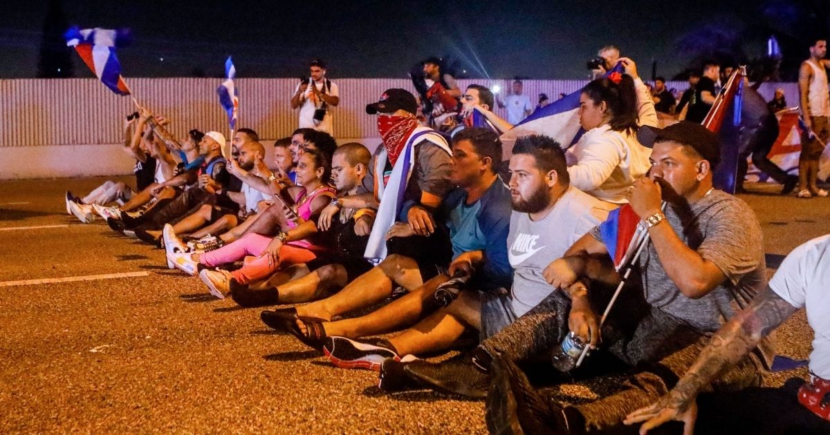 People block Palmetto Expressway during a protest showing support for Cubans demonstrating against their government, in Miami, on Tuesday.